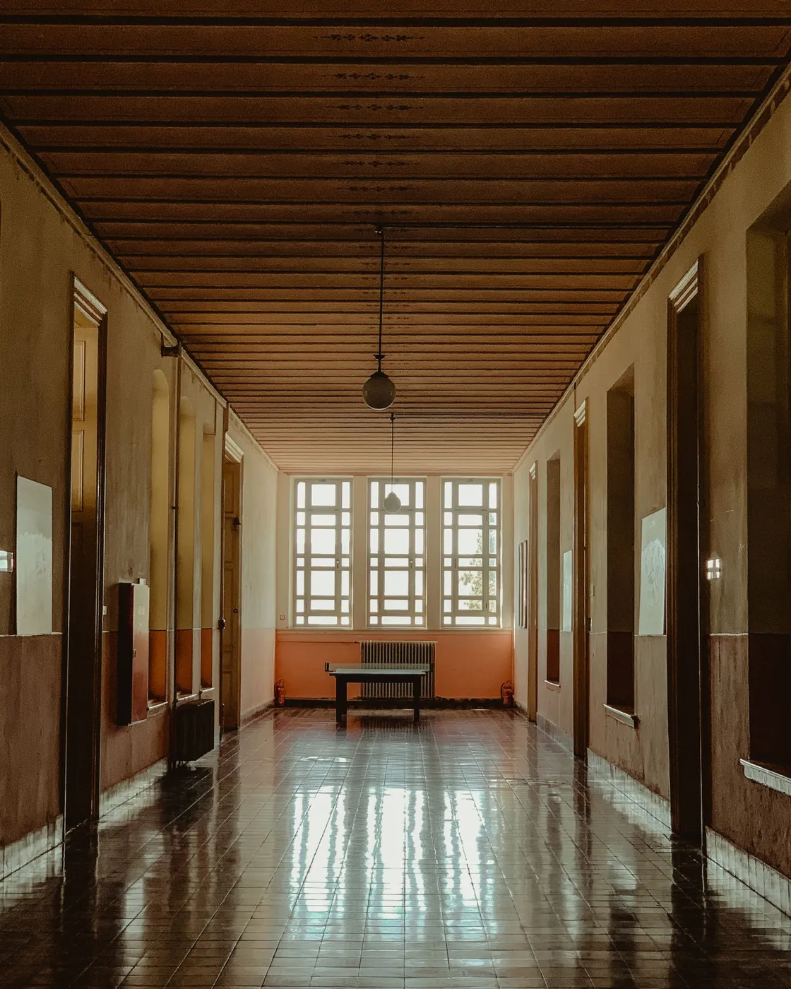 Shared indoor corridor with doors and lighting
